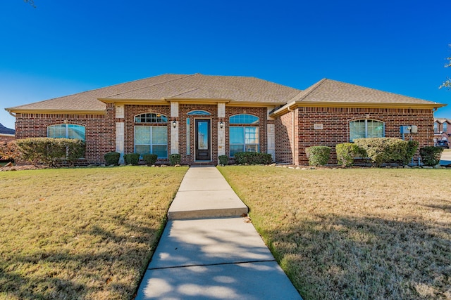 ranch-style home featuring a front yard