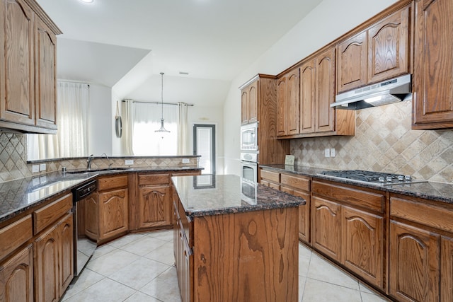 kitchen featuring a center island, light tile patterned flooring, pendant lighting, and appliances with stainless steel finishes