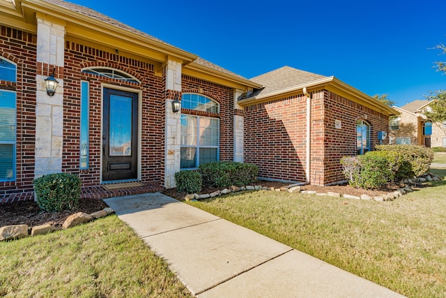 property entrance with a yard