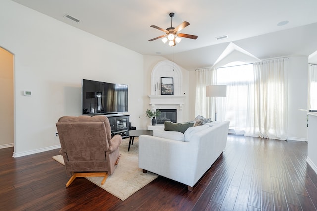 living room featuring ceiling fan, dark hardwood / wood-style flooring, and vaulted ceiling