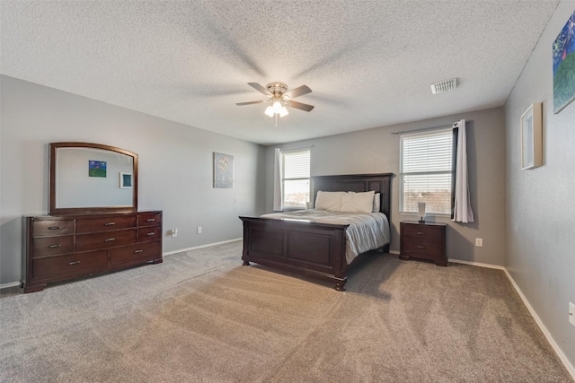 bedroom with carpet, visible vents, ceiling fan, a textured ceiling, and baseboards