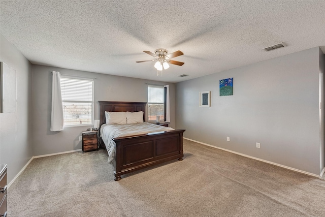 bedroom with baseboards, visible vents, ceiling fan, and light colored carpet