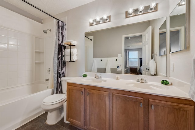 bathroom featuring double vanity, shower / bath combo, a sink, and toilet