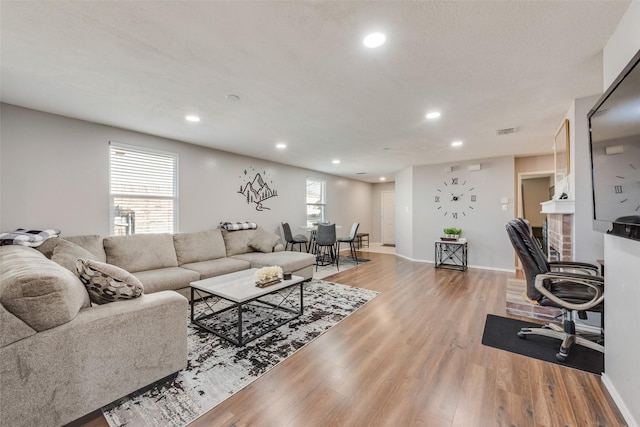 living area featuring recessed lighting, a healthy amount of sunlight, and light wood-style flooring