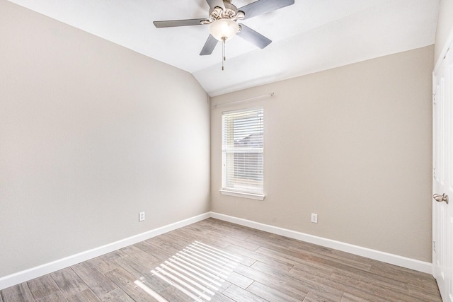 spare room featuring hardwood / wood-style flooring, ceiling fan, and vaulted ceiling