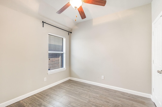 spare room with wood-type flooring and ceiling fan