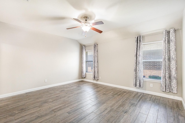 unfurnished room featuring plenty of natural light, ceiling fan, lofted ceiling, and dark wood-type flooring