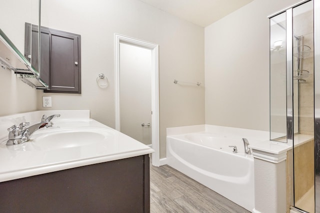 bathroom featuring hardwood / wood-style floors, vanity, and shower with separate bathtub