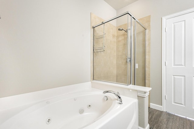 bathroom with hardwood / wood-style floors and separate shower and tub