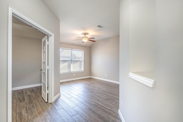 spare room featuring hardwood / wood-style flooring and ceiling fan