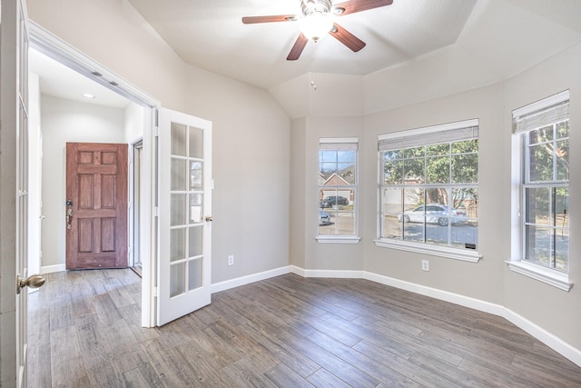 empty room featuring ceiling fan, french doors, vaulted ceiling, and hardwood / wood-style flooring