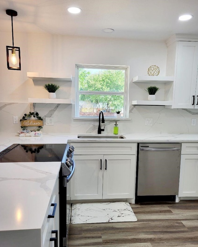 kitchen with dishwasher, white cabinets, sink, electric range, and decorative light fixtures