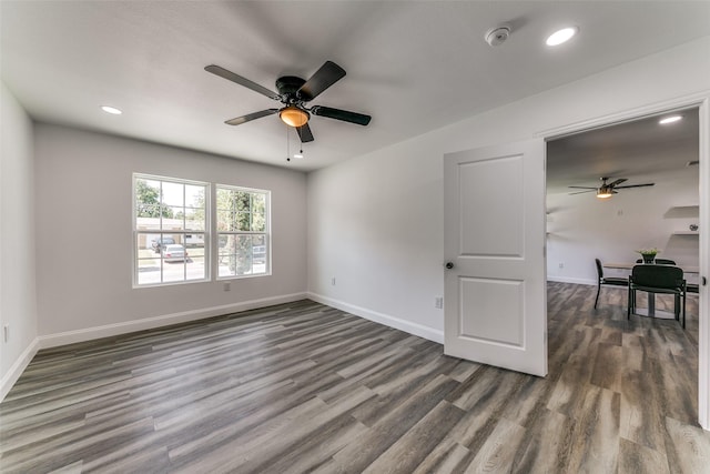 spare room with ceiling fan and dark hardwood / wood-style floors