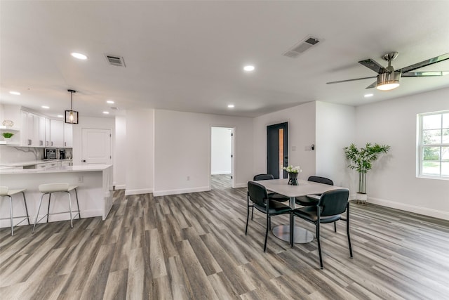 dining room with ceiling fan and light hardwood / wood-style flooring