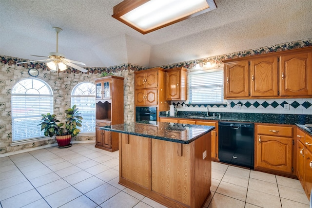 kitchen with a center island, black appliances, a textured ceiling, and sink