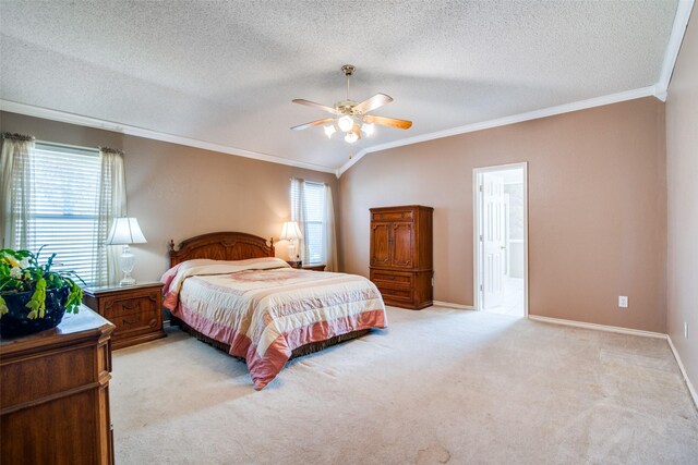 carpeted bedroom featuring ensuite bathroom, crown molding, ceiling fan, and vaulted ceiling