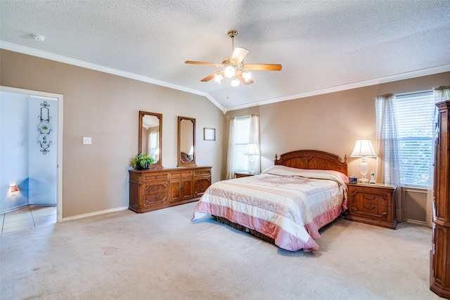 carpeted bedroom with multiple windows, ceiling fan, crown molding, and vaulted ceiling