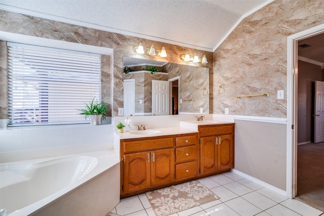 bathroom with vanity, tile patterned flooring, a washtub, ornamental molding, and a textured ceiling