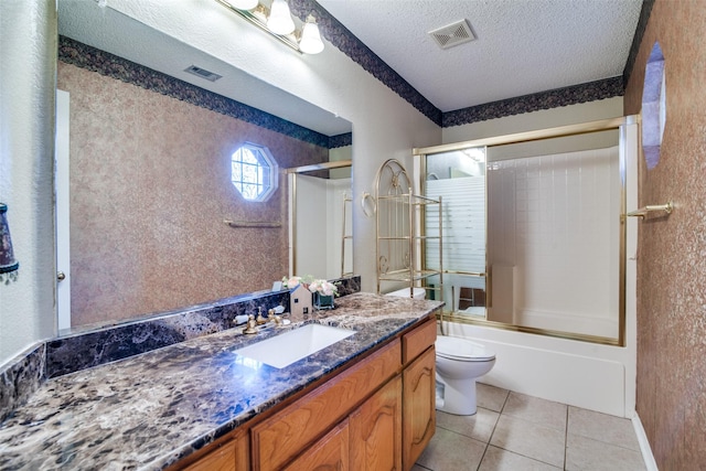 full bathroom with tile patterned floors, vanity, a textured ceiling, enclosed tub / shower combo, and toilet