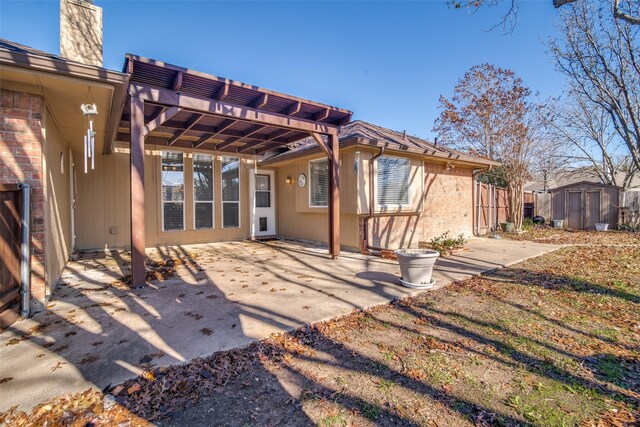 rear view of house featuring a storage unit, a pergola, and a patio