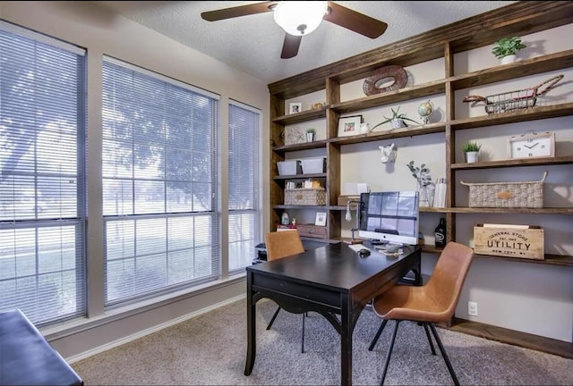 home office featuring carpet flooring, a textured ceiling, and ceiling fan