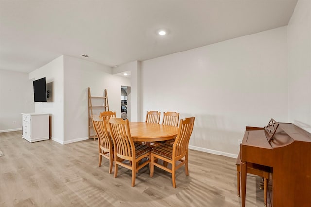 dining area with light hardwood / wood-style flooring