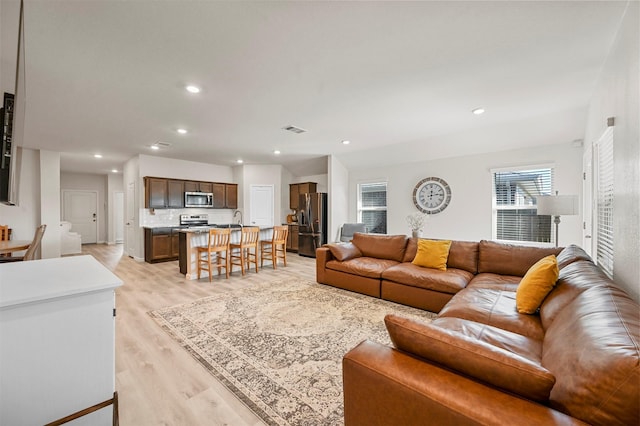 living room with light hardwood / wood-style flooring