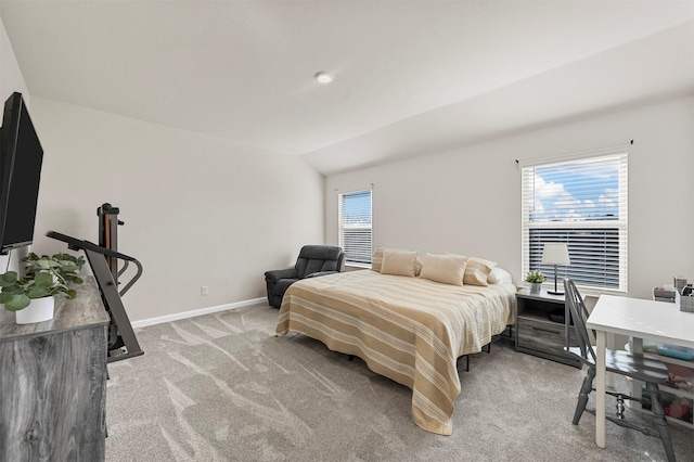 carpeted bedroom with multiple windows and lofted ceiling