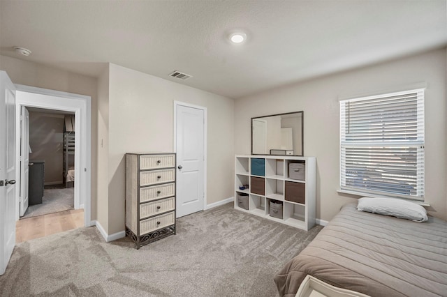 bedroom featuring light colored carpet