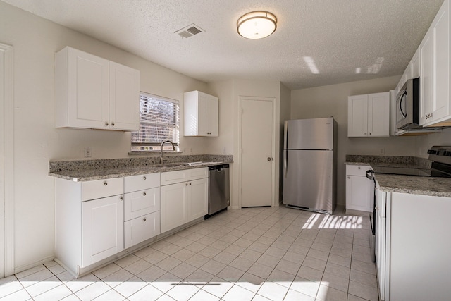 kitchen with sink, white cabinets, and appliances with stainless steel finishes