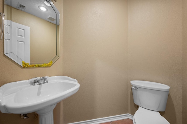 bathroom featuring sink and toilet