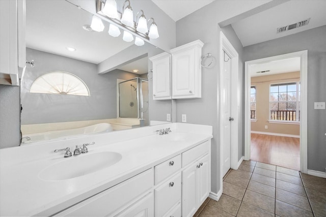 bathroom with vanity, tile patterned floors, independent shower and bath, and a healthy amount of sunlight