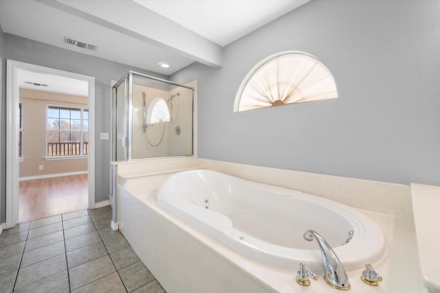 bathroom with tile patterned flooring and independent shower and bath