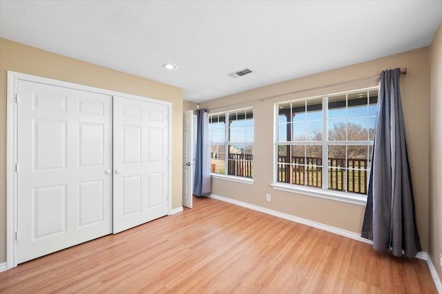 unfurnished bedroom featuring hardwood / wood-style flooring and a closet