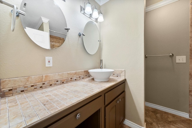 bathroom with ornamental molding and vanity