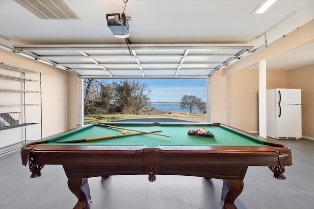 game room featuring billiards, concrete flooring, and a water view