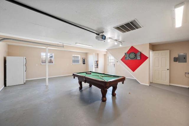 rec room featuring billiards, concrete flooring, electric panel, and a textured ceiling