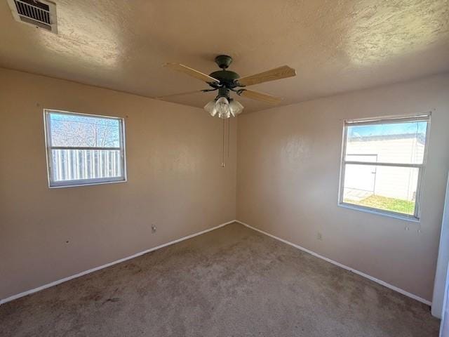 spare room with ceiling fan and carpet floors