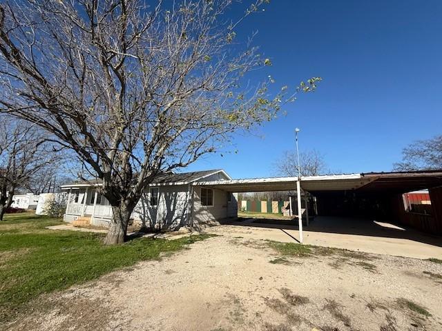 back of house with a carport