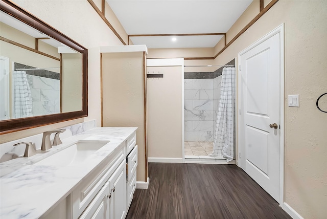 bathroom with a shower with shower curtain, vanity, and hardwood / wood-style floors