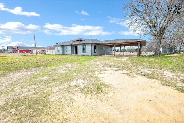 exterior space with a front lawn and a carport