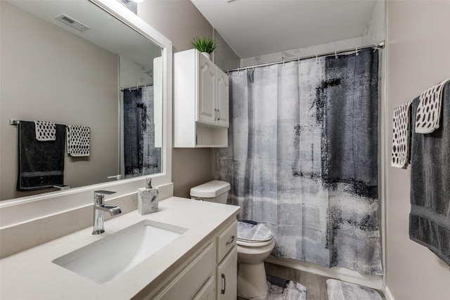 bathroom featuring vanity, hardwood / wood-style flooring, and toilet