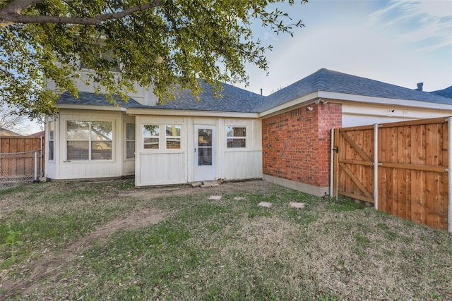 rear view of house with a lawn