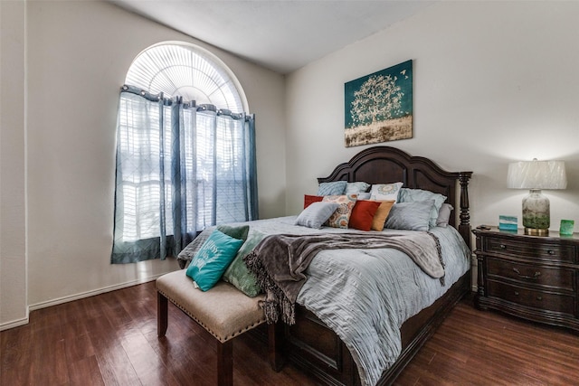 bedroom featuring dark hardwood / wood-style flooring and multiple windows