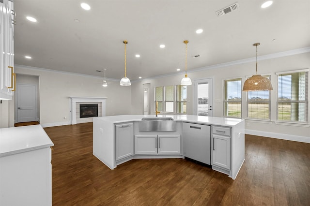 kitchen with white cabinets, sink, an island with sink, and stainless steel dishwasher