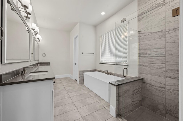 bathroom featuring tile patterned floors, vanity, and shower with separate bathtub