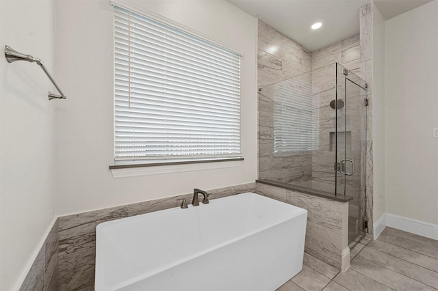 bathroom featuring plus walk in shower and tile patterned floors