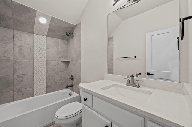 full bathroom featuring vanity, toilet, lofted ceiling, and tiled shower / bath