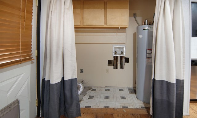 clothes washing area with electric dryer hookup and water heater