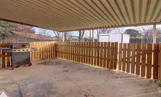 view of patio / terrace with a wooden deck and grilling area